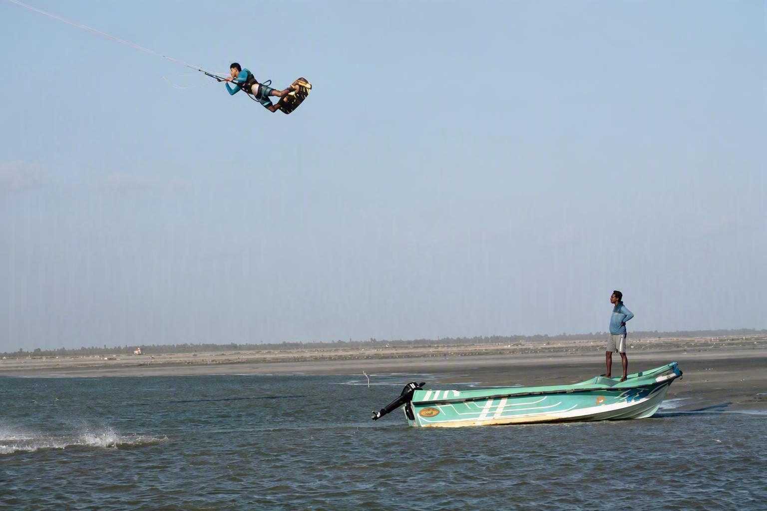 Kitesurfer jumping over the shallow lagoon in Mannar, Sri Lanka.